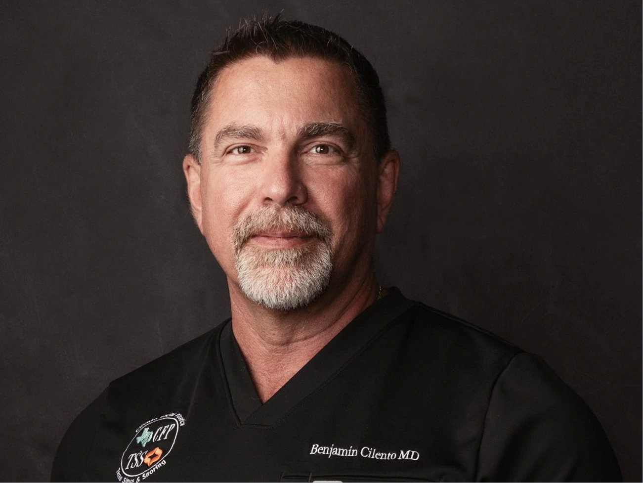 Benjamin Cliento MD in black medical scrubs with logo