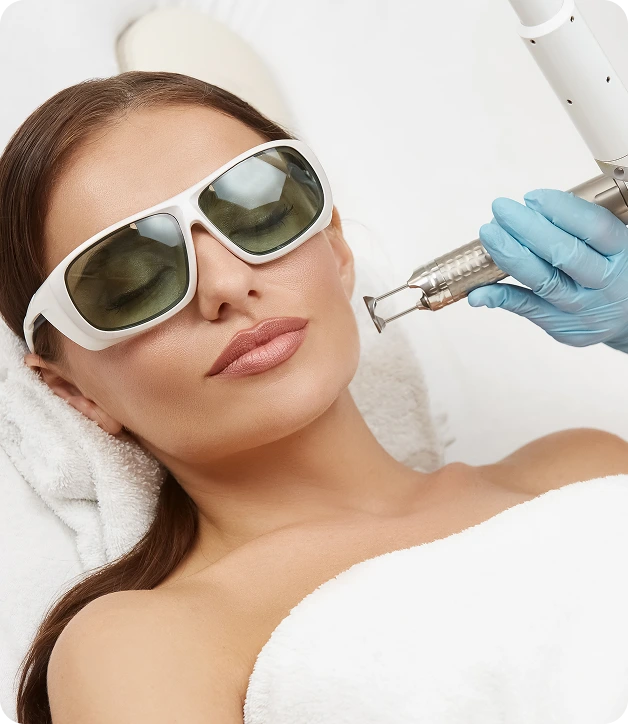 Woman wearing protective eyewear receiving laser skin treatment on her face